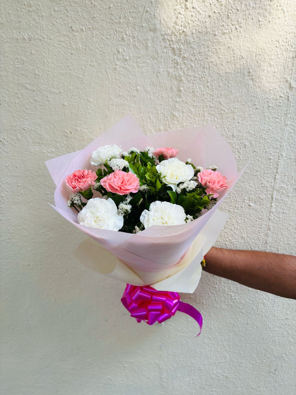 Pink Carnations hand bouquet by BloomOnly who is a premium number 1 florist in pune that delivers same day